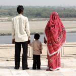 A family watches the sacred Yamuna River from the marble plinth surrounding the Taj Mahal, Agra, India. © copyright Matthew Brace